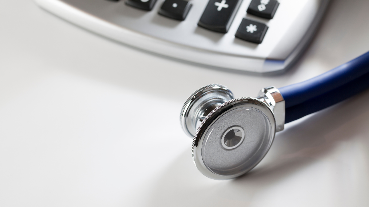 What Is Direct Primary Care? How It Works, What It Costs and Who It's For 3 Stethoscope resting next to a calculator